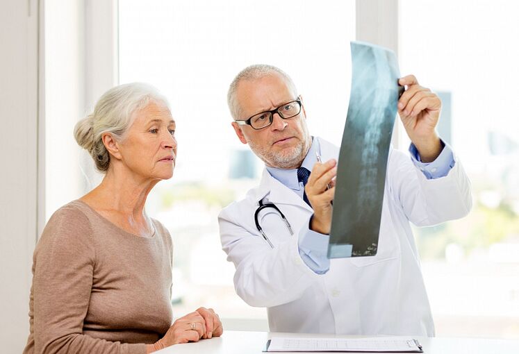 A doctor determines cervical osteochondrosis in a patient using radiography